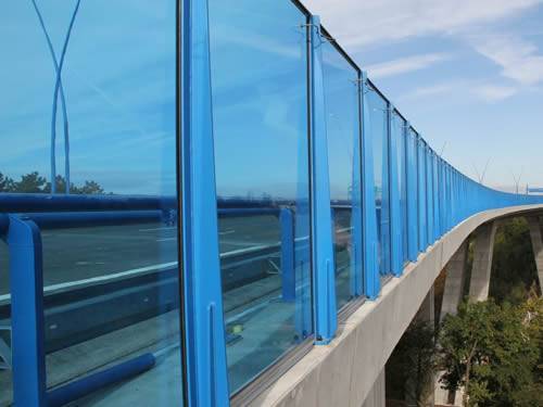 Blue polycarbonate sheets used as bridge acoustic barrier.